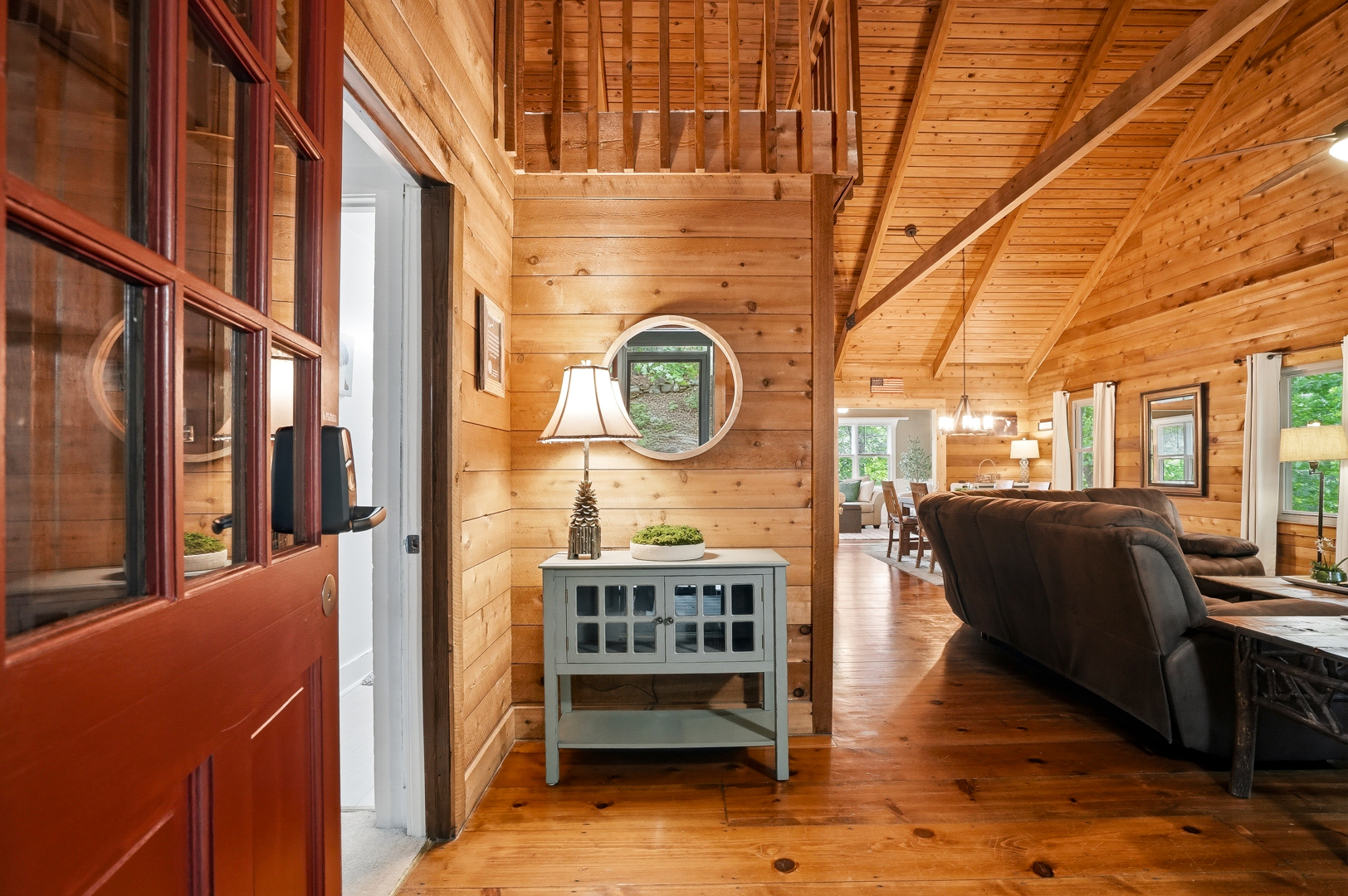 Cabin entry with red front door and wood walls