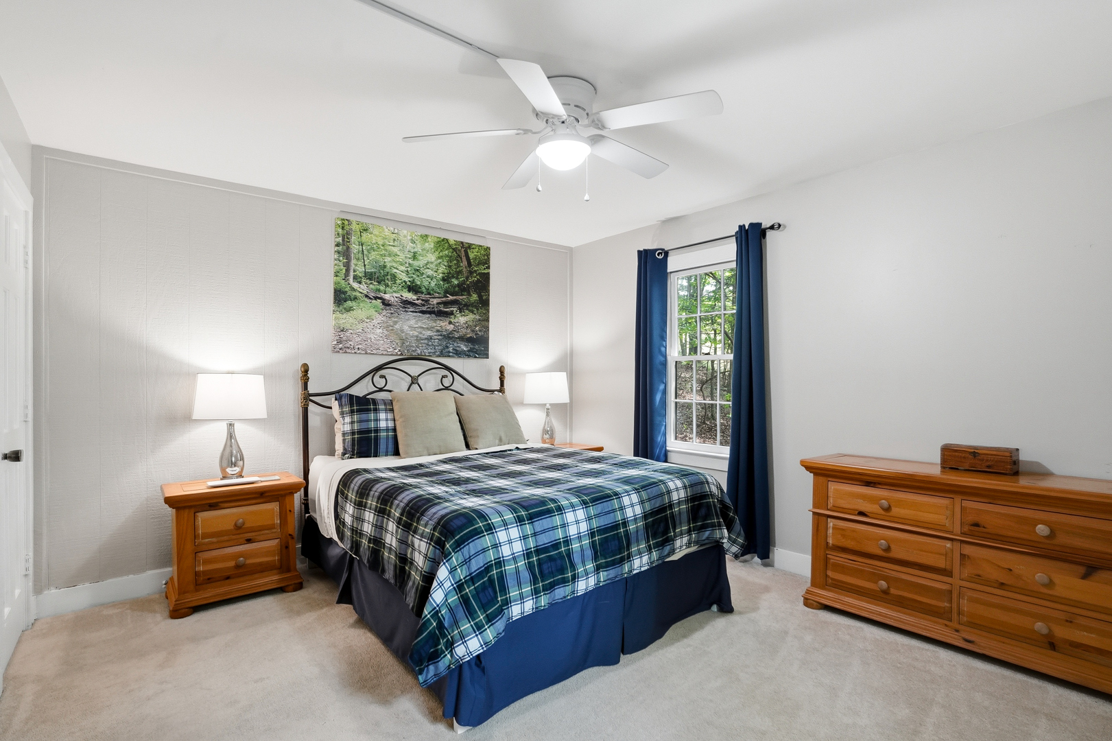 Queen bedroom with blue plaid bedding