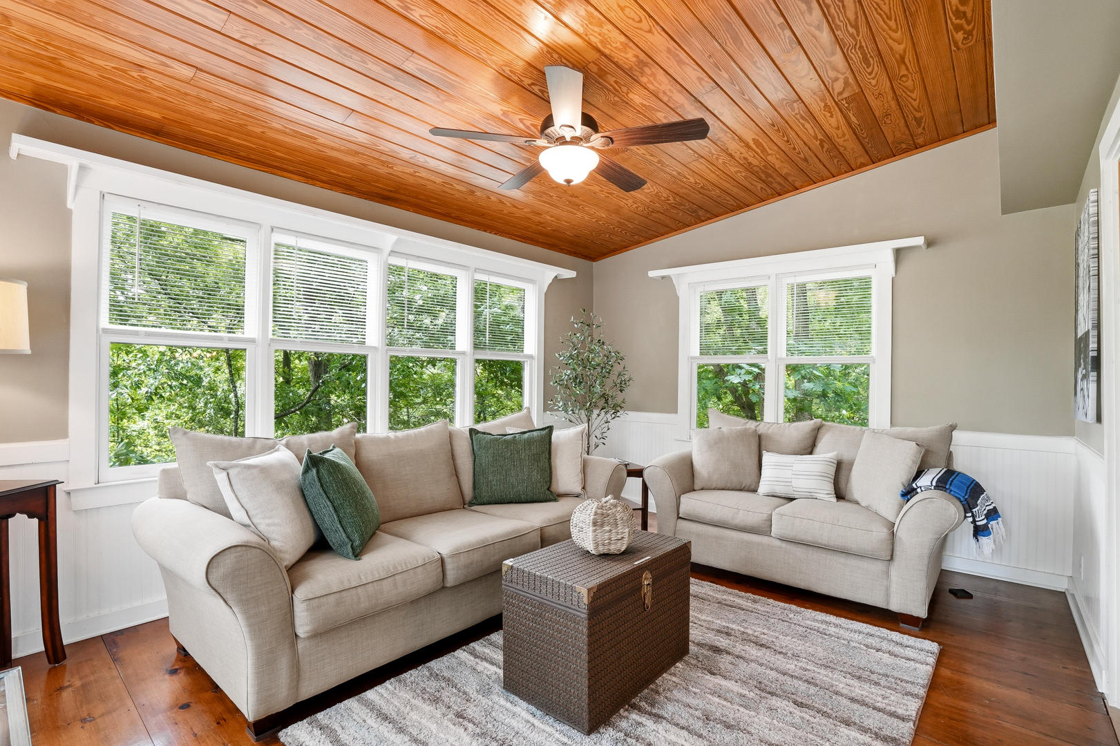 Sunroom with sofas and windows on the woods