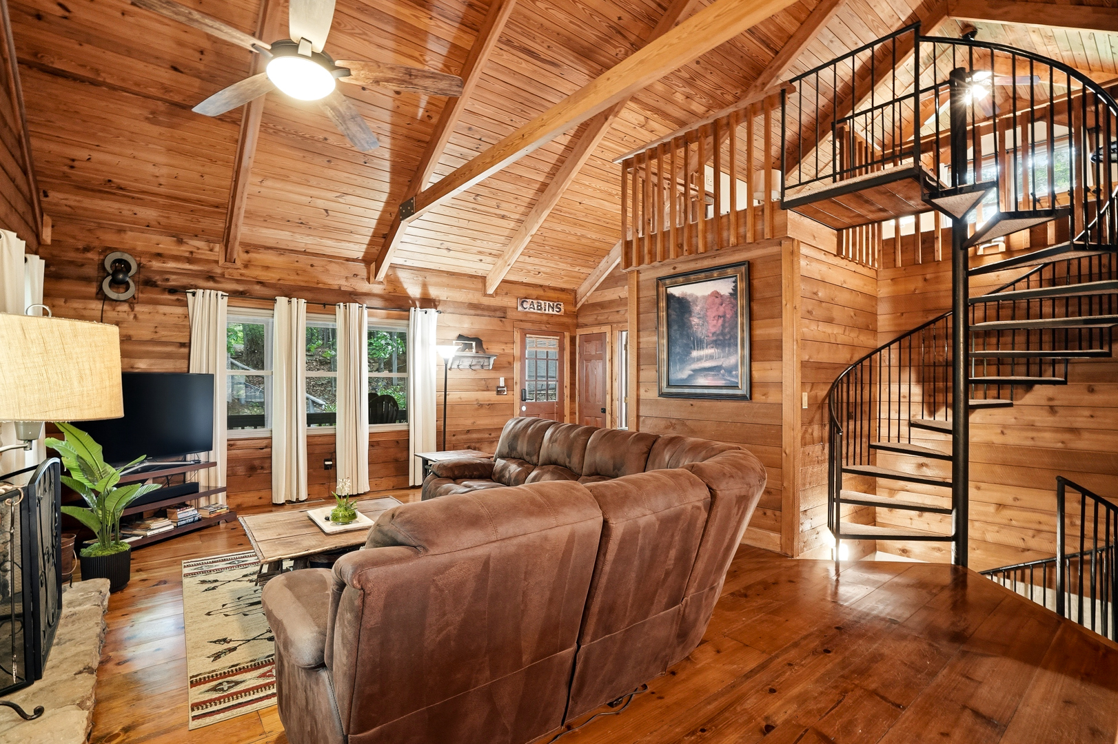 Second living area with TV and spiral staircase