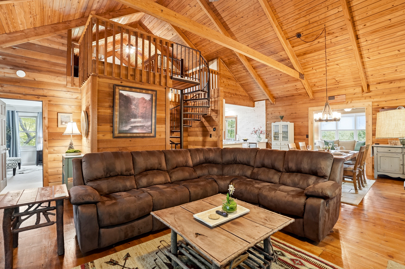 Living room sectional with spiral staircase to the loft